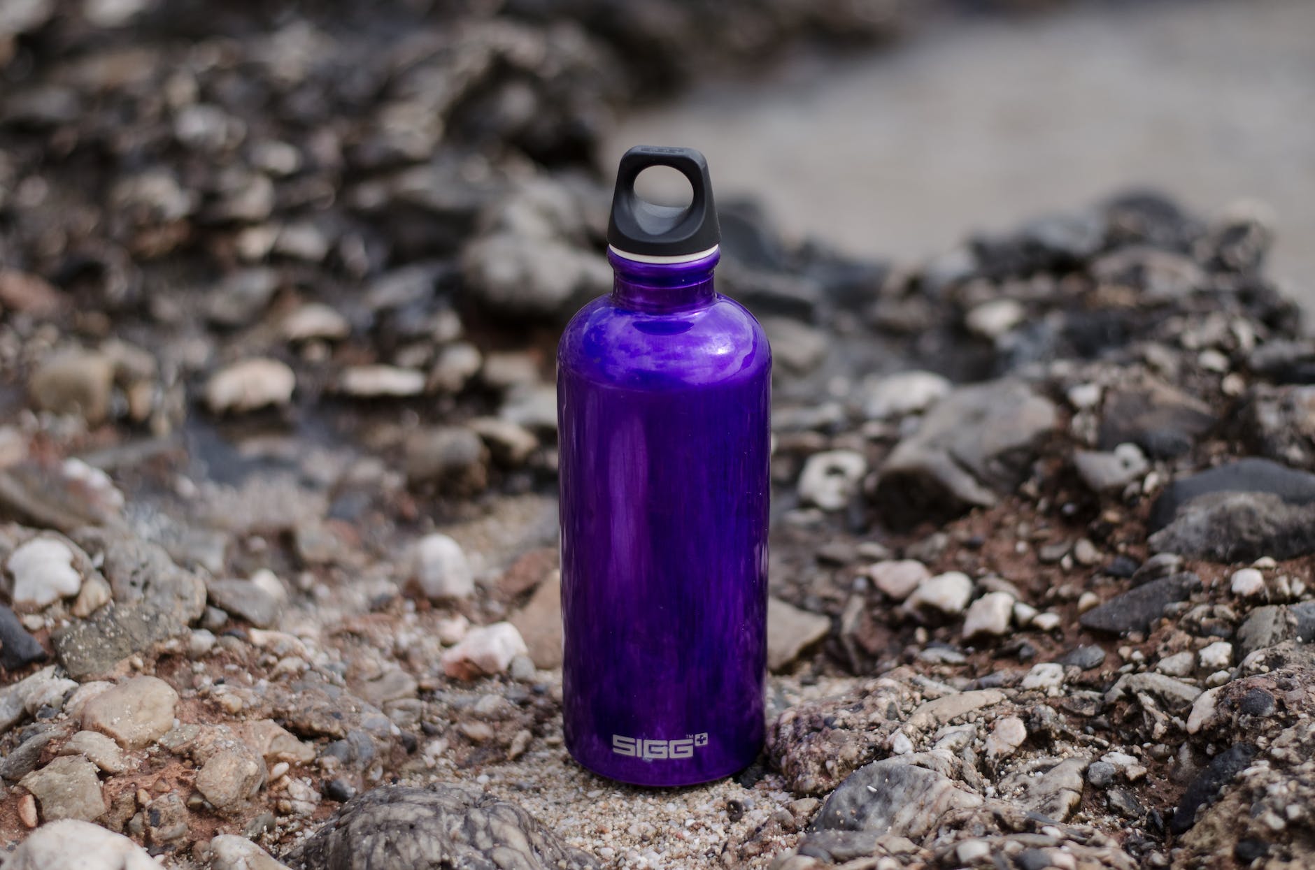 purple sports bottle on ground